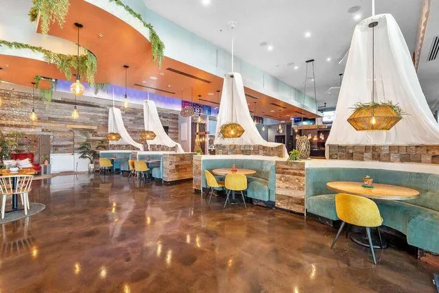 a living room with lots of furniture and a wooden floor