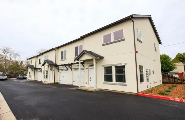 a front view of a house with a street