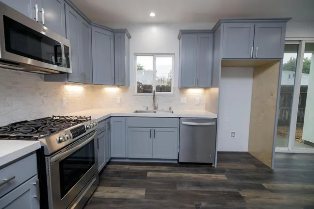 a kitchen with a sink stove and microwave