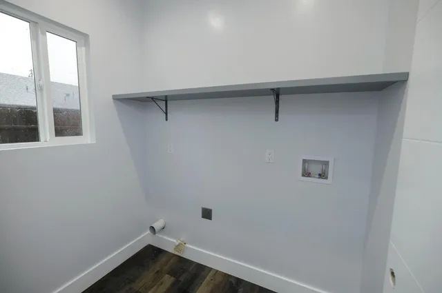 a view of a room with wooden floor