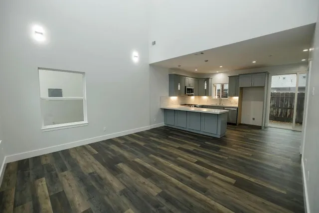 a living room with kitchen island furniture and a kitchen view