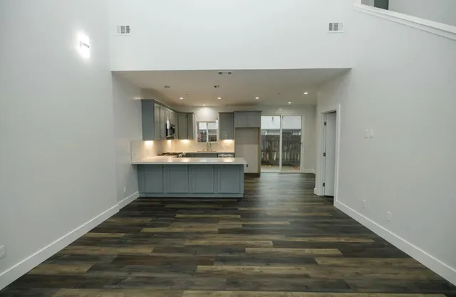 a kitchen with kitchen island a sink stainless steel appliances and counter space