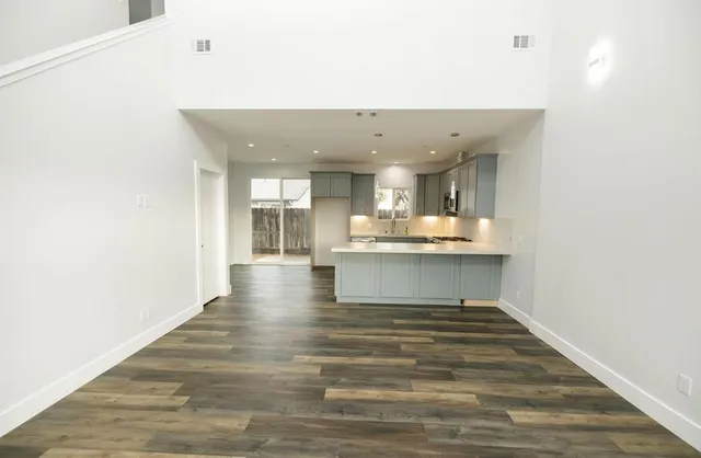 a large kitchen with kitchen island a sink stainless steel appliances and cabinets