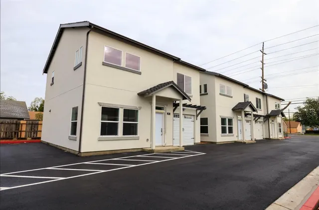 a front view of a house with a street