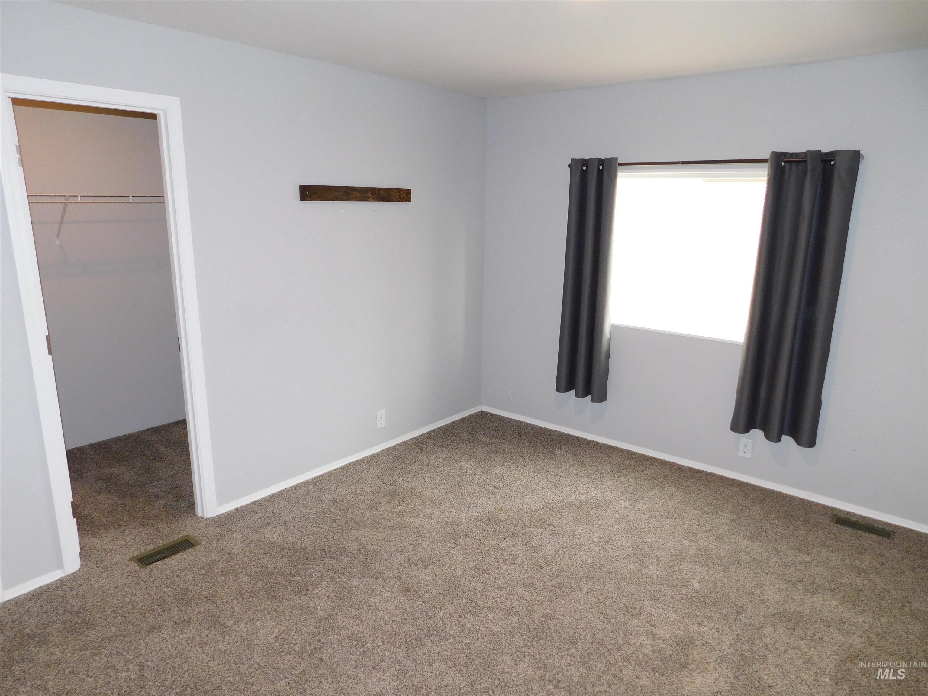 26915 Chips Lane Parma, ID 83660 - Photo 14 of 48 Unfurnished bedroom featuring a spacious closet and carpet flooring