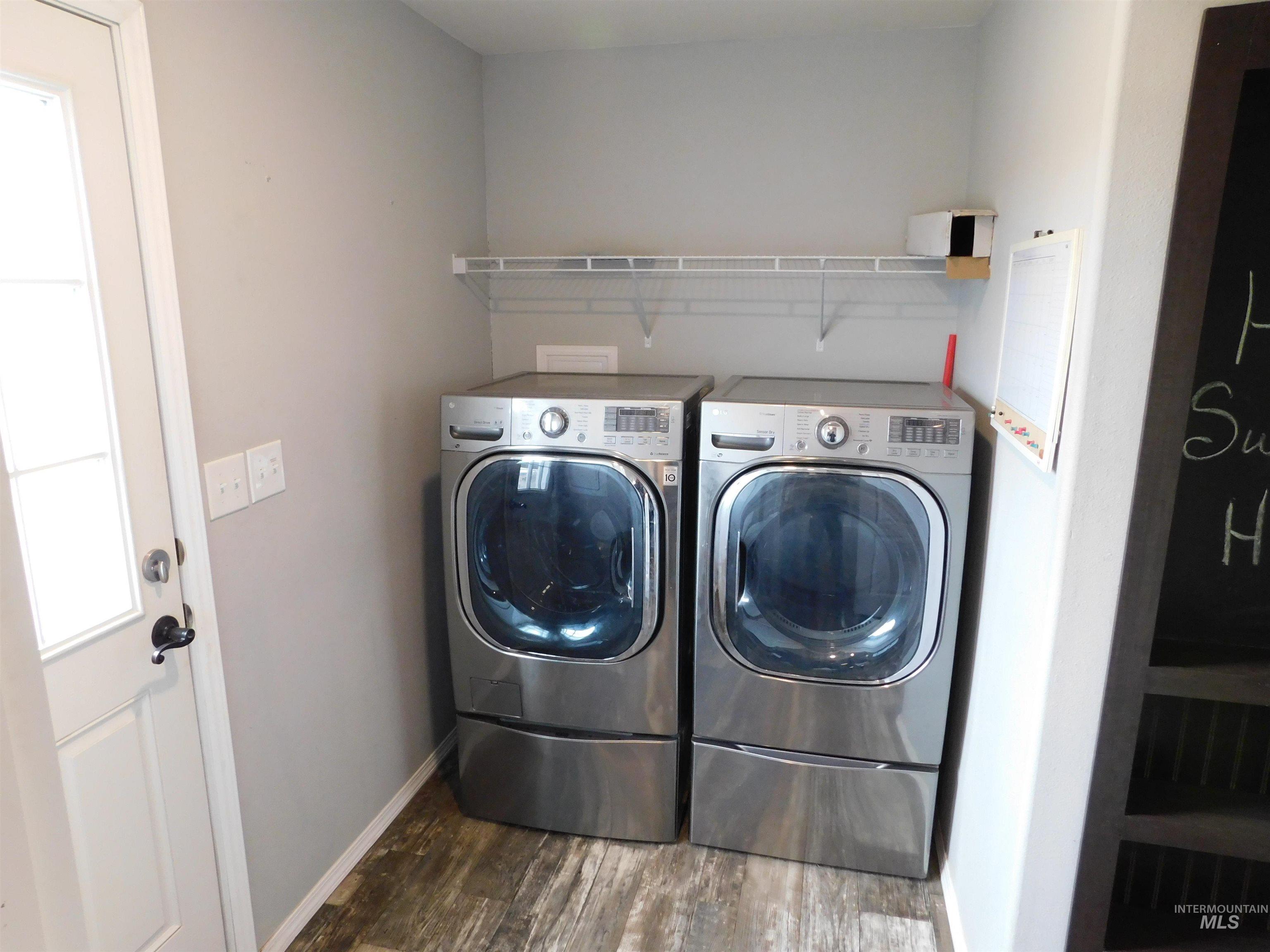 26915 Chips Lane Parma, ID 83660 - Photo 17 of 48 Laundry room with washing machine and clothes dryer and dark wood-style flooring
