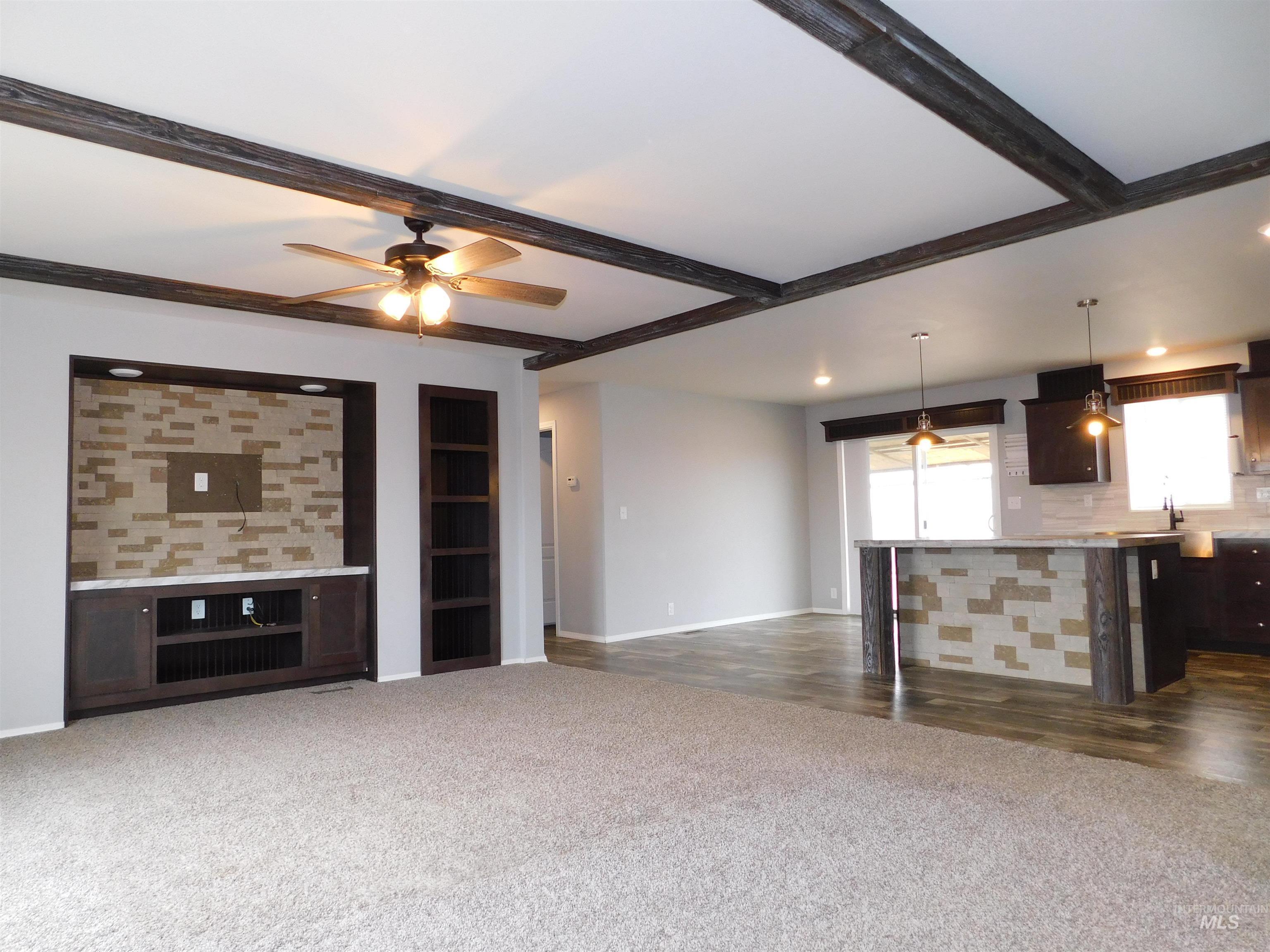 26915 Chips Lane Parma, ID 83660 - Photo 2 of 48 Unfurnished living room featuring dark colored carpet, ceiling fan, recessed lighting, and beamed ceiling