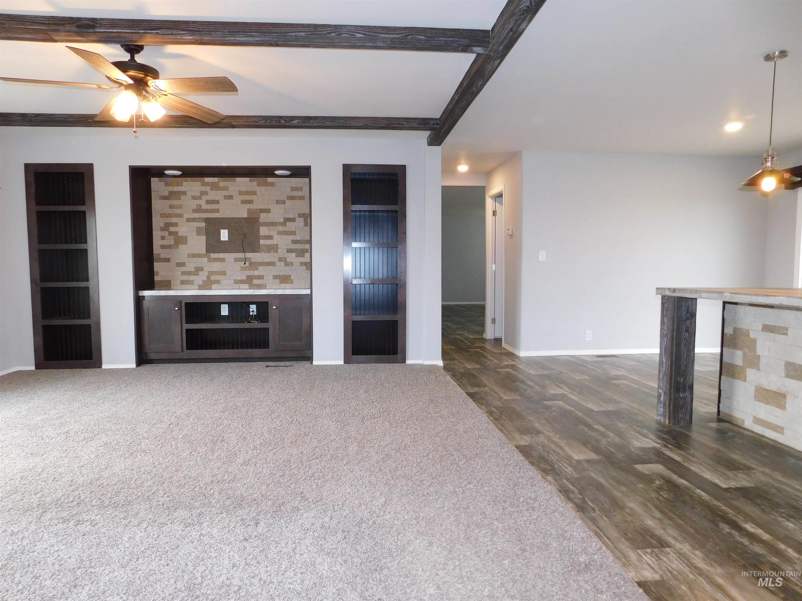 26915 Chips Lane Parma, ID 83660 - Photo 3 of 48 Unfurnished living room with a ceiling fan, recessed lighting, dark wood-type flooring, and dark carpet