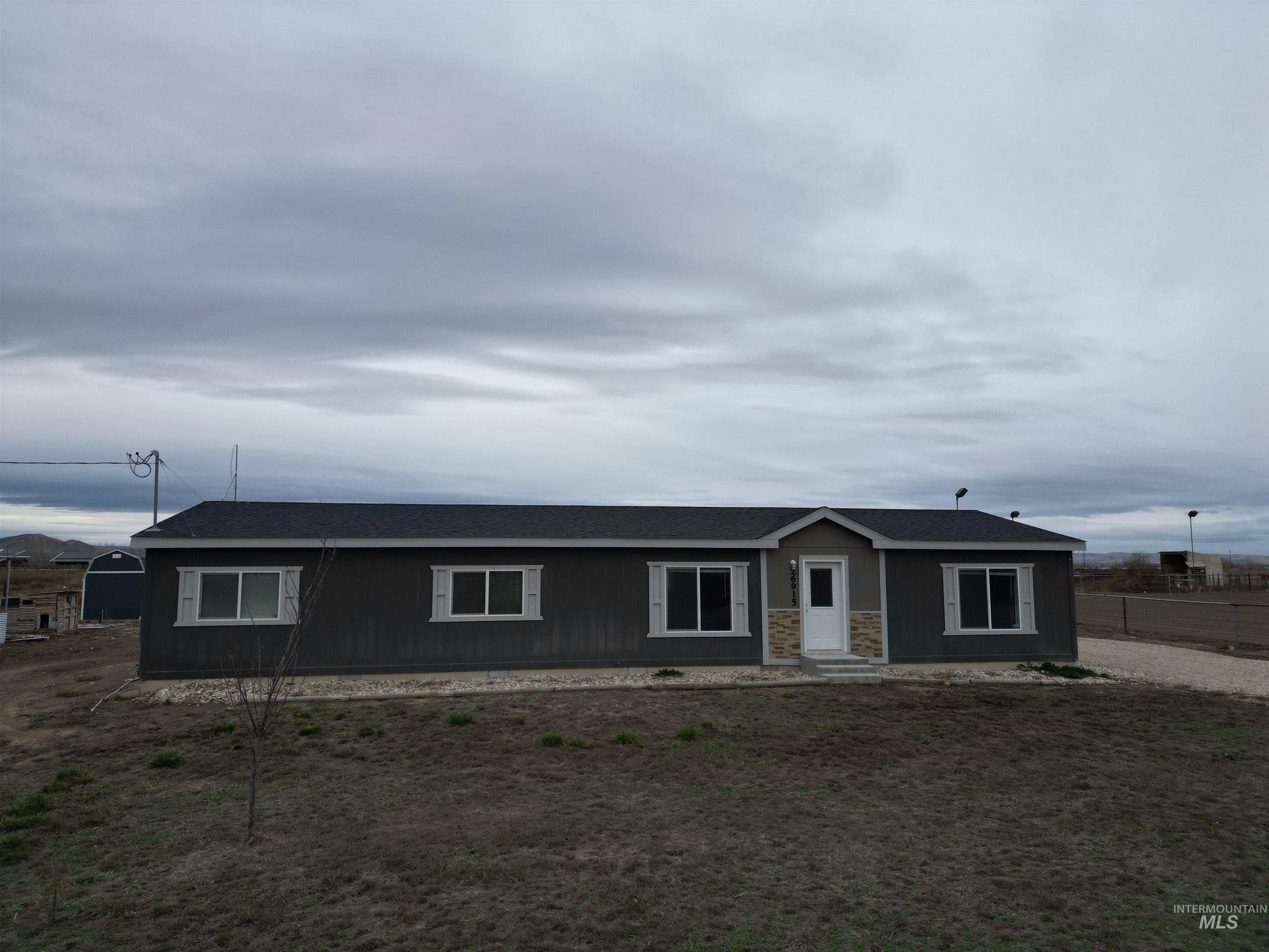 26915 Chips Lane Parma, ID 83660 - Photo 46 of 48 Ranch-style house featuring a shingled roof and stone siding