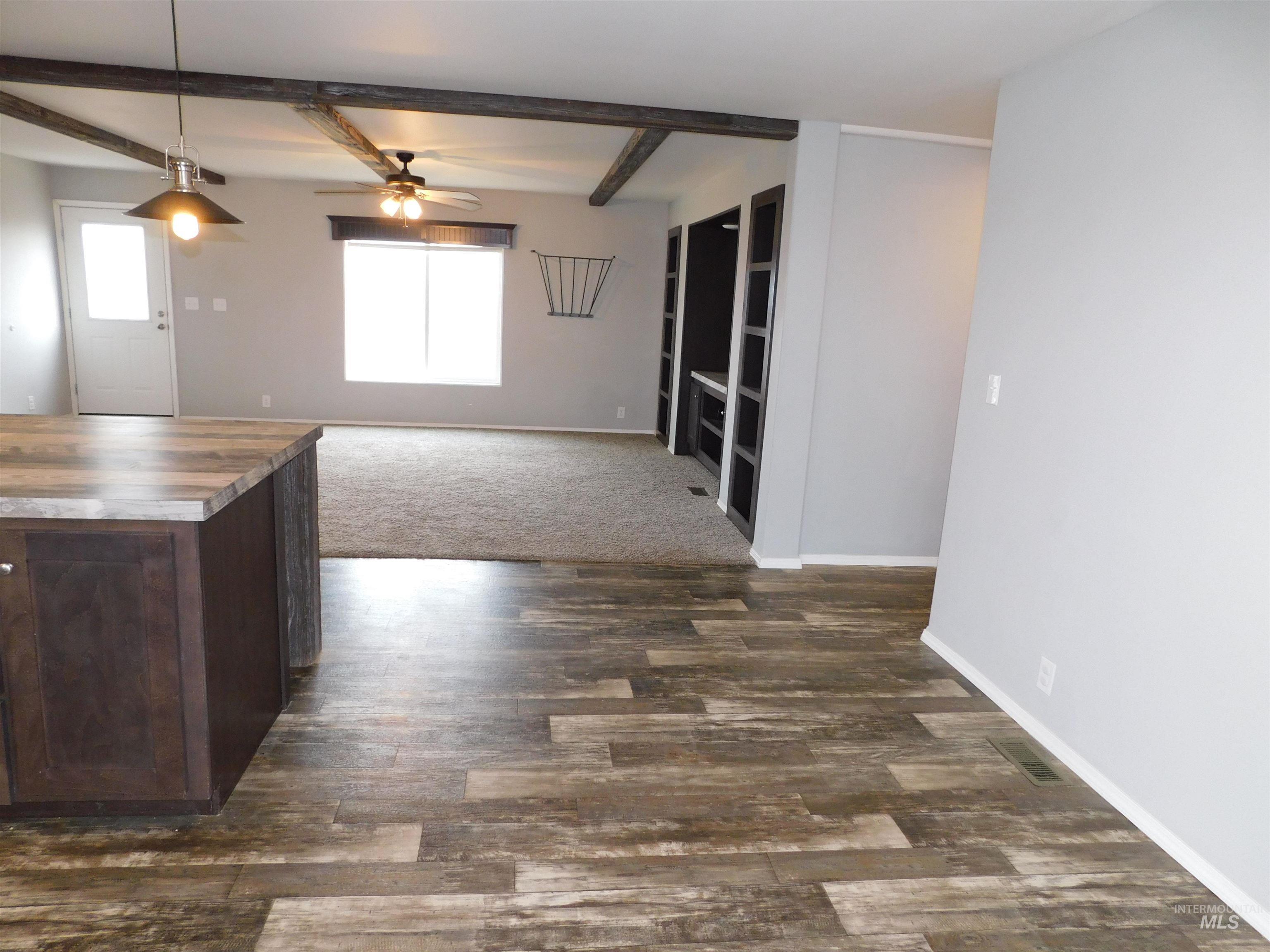 26915 Chips Lane Parma, ID 83660 - Photo 48 of 48 Kitchen with wood counters, beam ceiling, hanging light fixtures, ceiling fan, and open floor plan