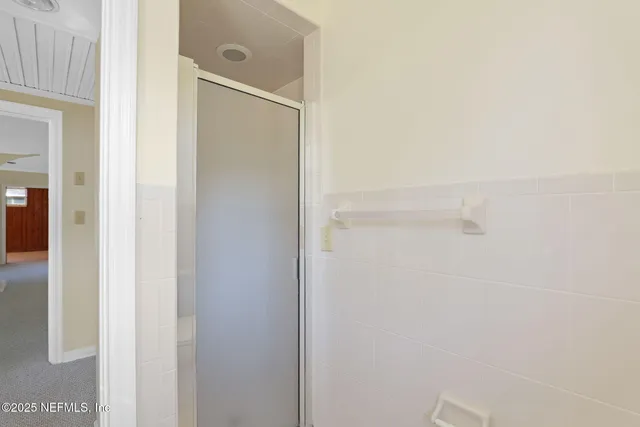 a bathroom with a glass shower door