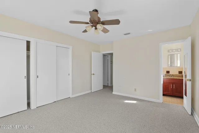 a view of a livingroom with a ceiling fan and wooden floor