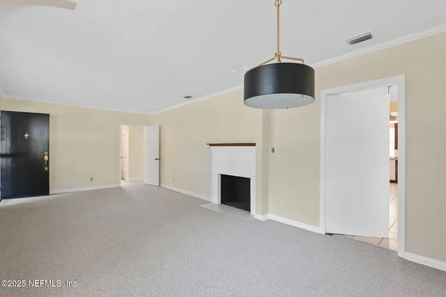 a view of an empty room with a fireplace