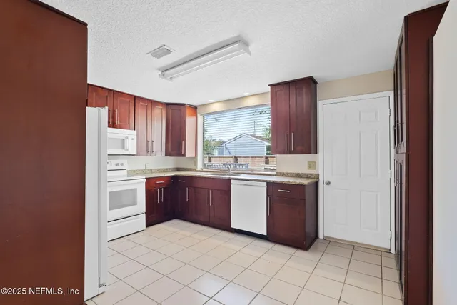 a kitchen with stainless steel appliances granite countertop a stove and a refrigerator
