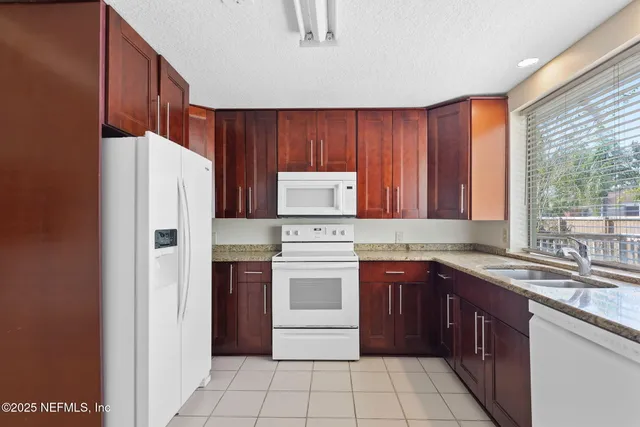 a kitchen with a stove top oven sink and cabinets