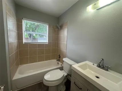 a bathroom with a sink toilet tub and shower