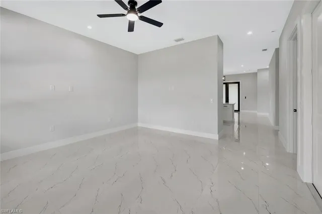 a view of a livingroom with a ceiling fan and window