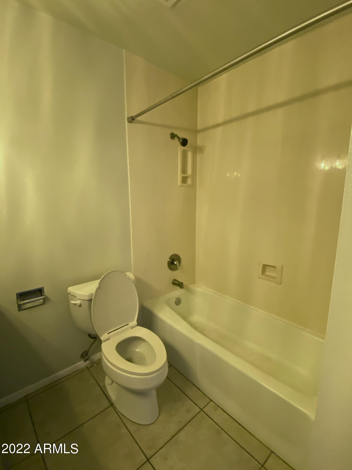 3244 West Yucca Street Phoenix, AZ 85029 - Photo 10 of 21 a white toilet sitting next to a bath tub and a shower
