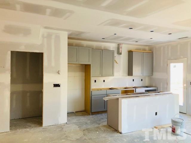 813 Star Rdg Drive Raleigh, NC 27610 - Photo 5 of 21 a kitchen with cabinets a sink and a refrigerator
