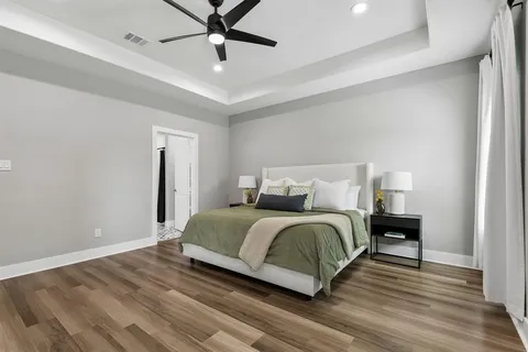 a bedroom with a bed and wooden floor