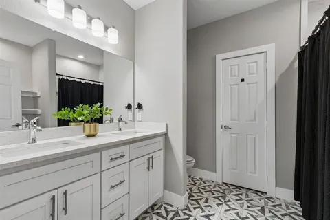 a bathroom with a sink a light fixture and a mirror