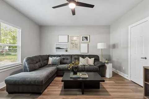 a living room with furniture and a large window