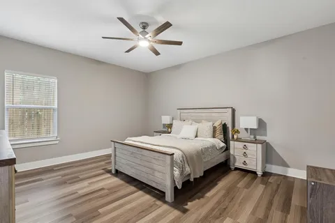 a bedroom with a bed and a large window