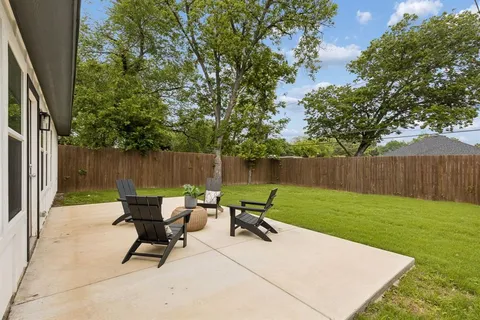 a view of a backyard with a table and chairs