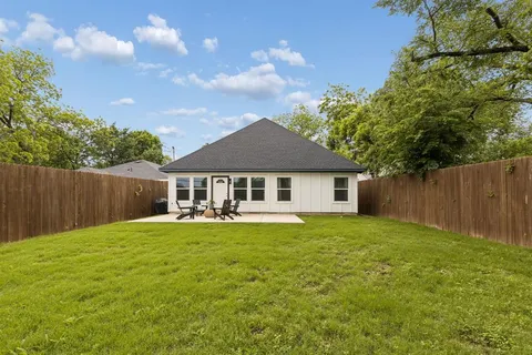 a front view of a house with yard and green space