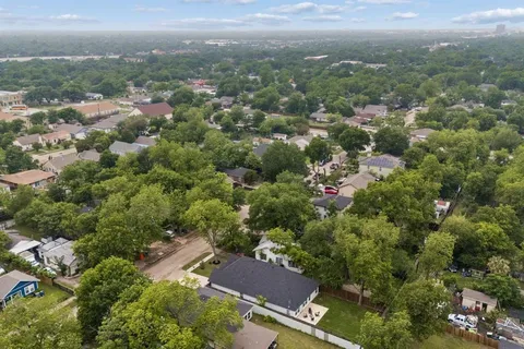 an aerial view of residential houses with city view