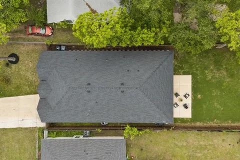 an aerial view of a residential houses with outdoor space