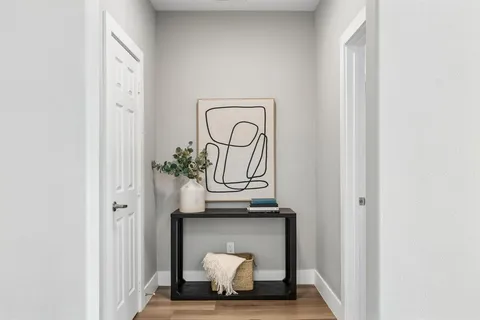 a view of front door with wooden floor