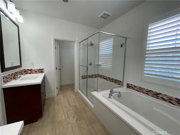 a bathroom with a granite countertop sink mirror bathtub and shower