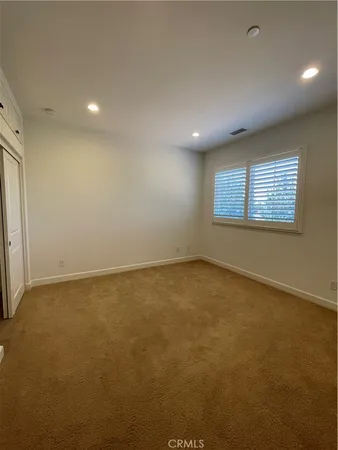 an empty room with a empty space and windows
