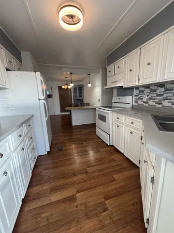 a kitchen with cabinets a sink and appliances