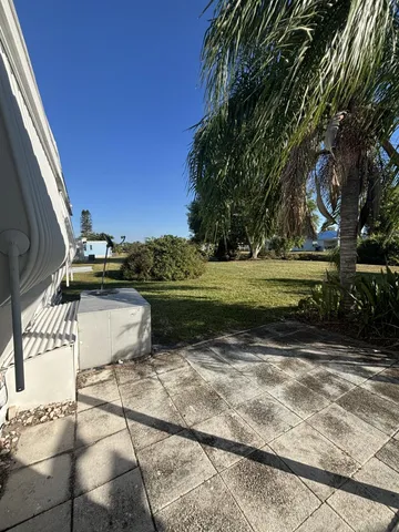 a view of a water pond with green yard