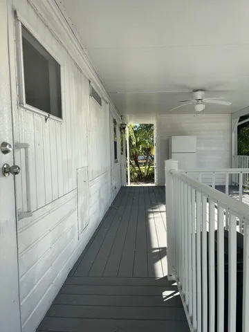 a view of hallway with stairs and wooden floor