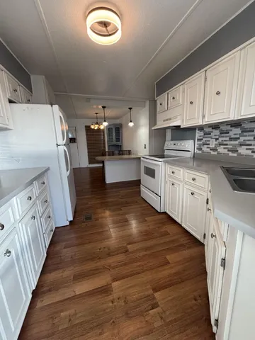 a kitchen with cabinets a sink and appliances
