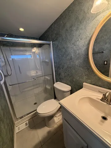 a bathroom with a sink toilet and shower