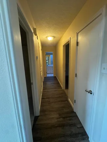a view of hallway with wooden floor