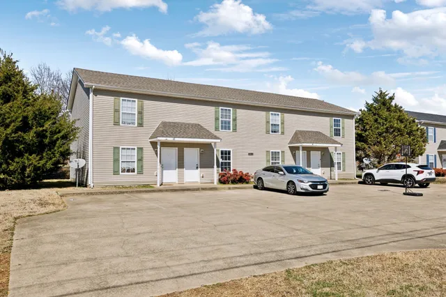 a view of a car parked in front of a house
