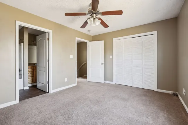 a view of empty room with ceiling fan