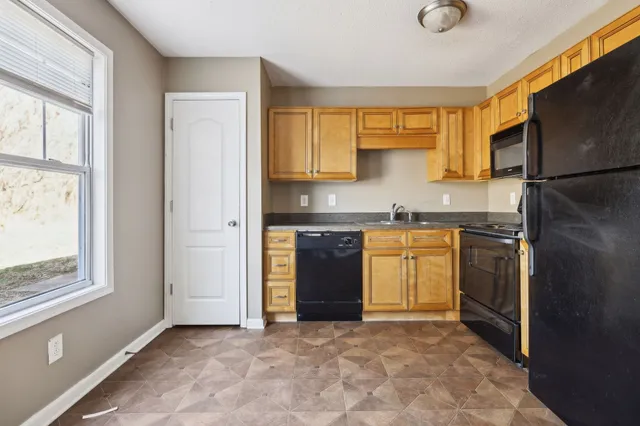 a kitchen with a stove a sink and a refrigerator