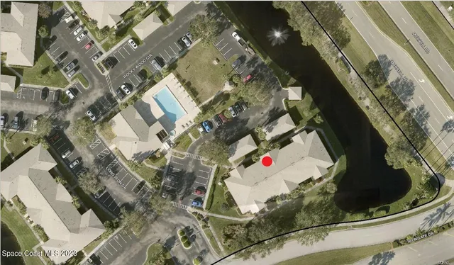 an aerial view of a house with a swimming pool