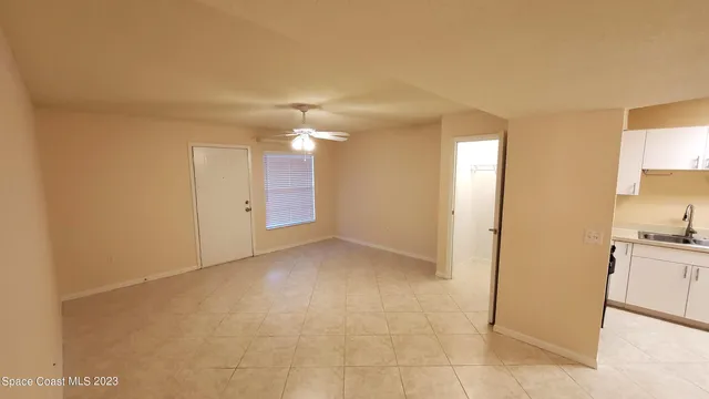 a view of a kitchen with a sink and dishwasher a refrigerator cabinets
