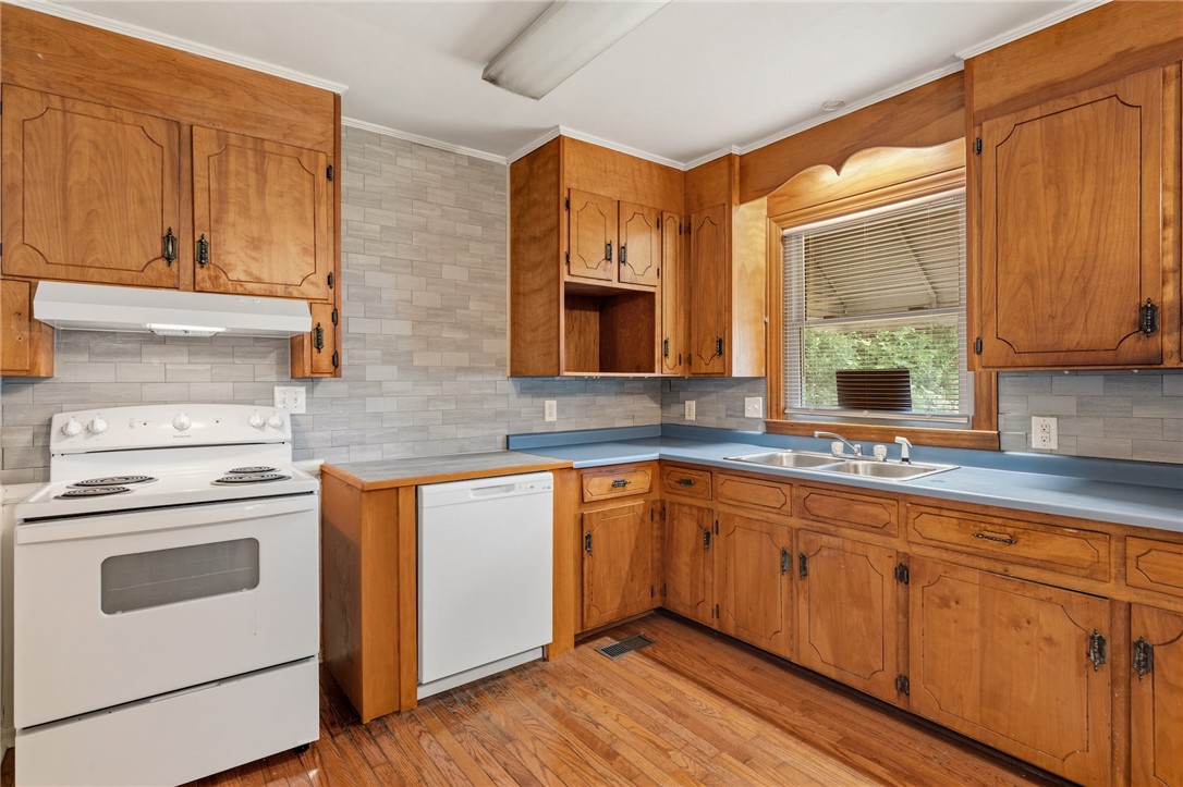 606 Perry Road Greenville, SC 29609 - Photo 10 of 22 Rich wood cabinetry provides a functional kitchen space.