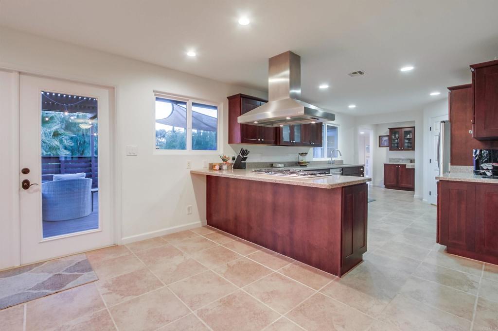 1321 Friends Way Fallbrook, CA 92028 - Photo 13 of 71 a kitchen with stainless steel appliances granite countertop a stove and a refrigerator
