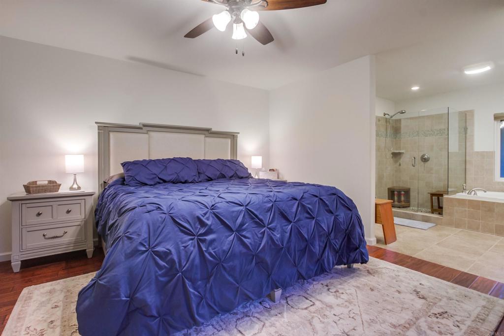 1321 Friends Way Fallbrook, CA 92028 - Photo 28 of 71 a bedroom with a large bed and a chandelier