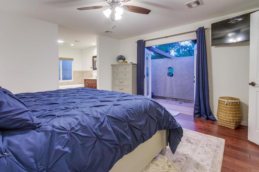 1321 Friends Way Fallbrook, CA 92028 - Photo 29 of 71 a bedroom with a bed and a chandelier