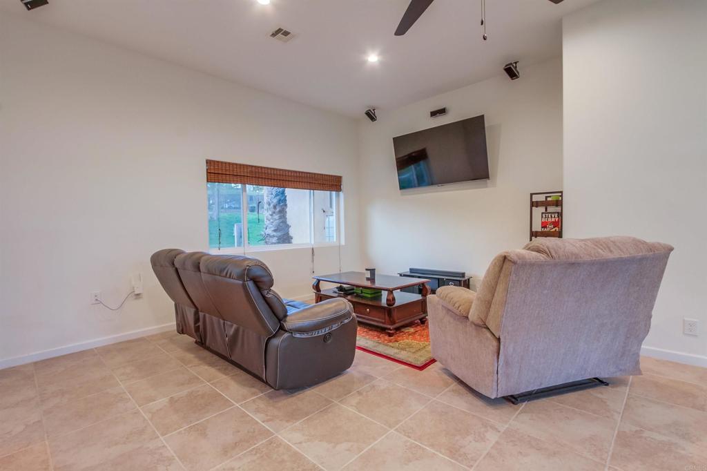 1321 Friends Way Fallbrook, CA 92028 - Photo 38 of 71 a living room with furniture a flat screen tv and a window